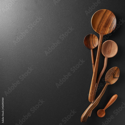 Wood spoons on black board background