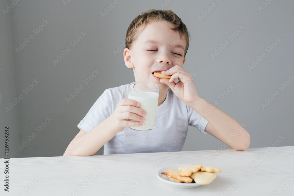The child is happy to eat homemade biscuits with milk The child is happy to eat homemade biscuits with milk