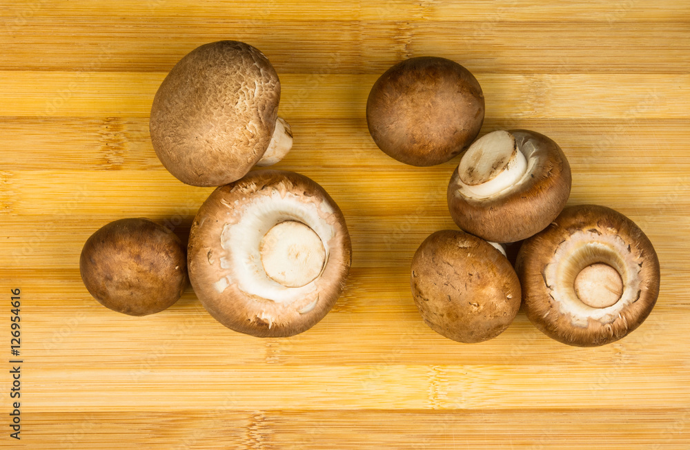 mushroom champignons on a wooden Board