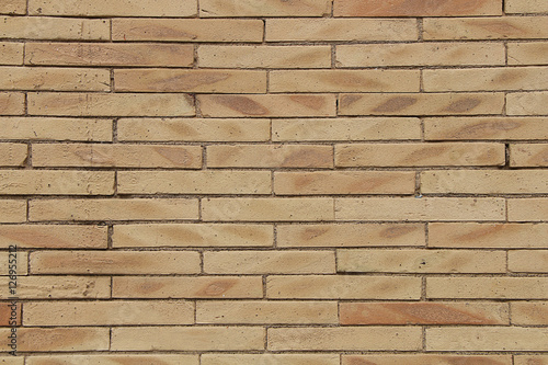 Texture - a wall of modern unusual yellow brick.
