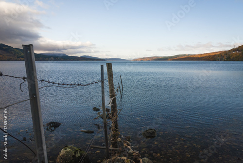 An old barbed wire fence leading into Loch Rannoch, Perth and Kinross, Scotland © espy3008
