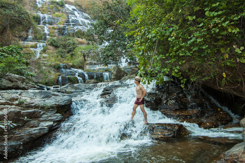 The man standing at Mae Ya Waterwall