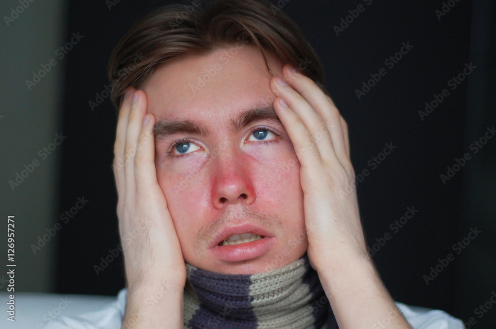 a young man suffering from a cold: chills, headache and stuffy nose a young man suffering from a cold: chills, headache and stuffy nose