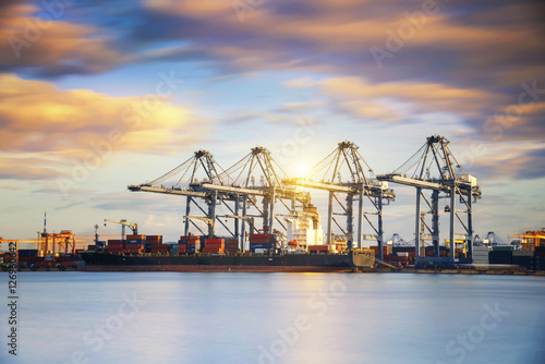 Containers loading by crane in the morning , Trade Port , Shipping