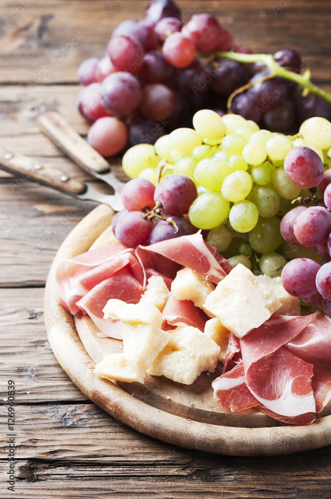 Antipasto with grape, cheese and ham