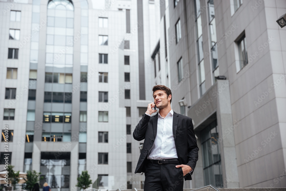 Businessman talking on mobile phone in the city Businessman talking on mobile phone in the city