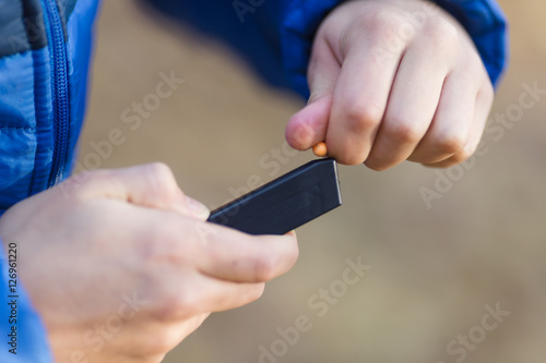 Wallpaper Mural boy playing with a toy gun on the street in autumn Torontodigital.ca
