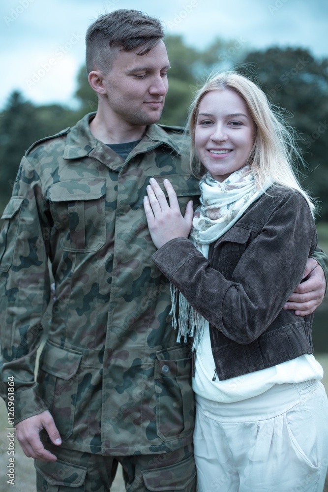 Soldier embracing his smiling wife Soldier embracing his smiling wife