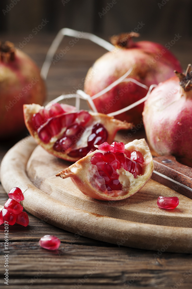 Italian red pomegranate on the wooden table Italian red pomegranate on the wooden table