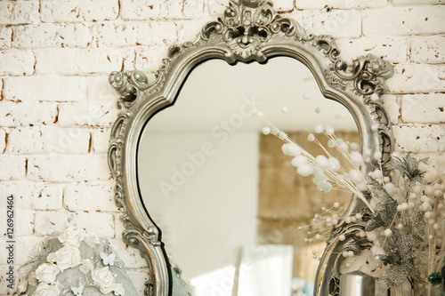 Vintage interior with a mirror in beautiful frame