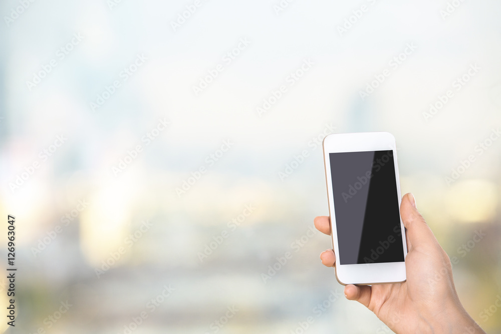 Woman holding blank smartphone