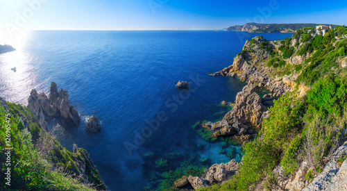 Landscape of beach in close bay with crystal clear azure water.