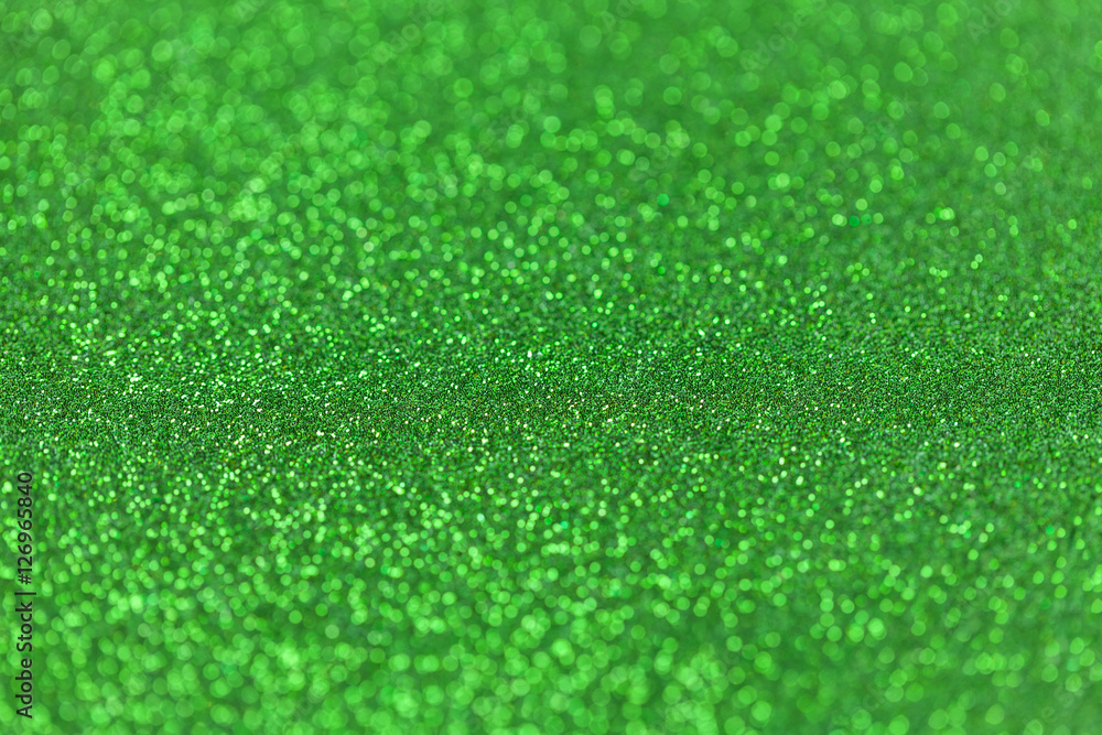 Fototapeta premium Green sparkling background from small sequins, closeup. Brilliant backdrop