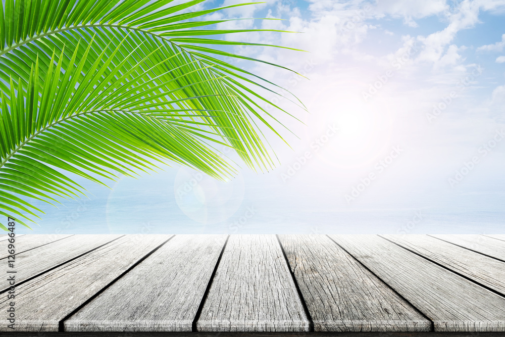 old wood table top on blurred beach background with coconut leaf. Concept Summer, Beach, Sea, Relax. old wood table top on blurred beach background with coconut leaf. Concept Summer, Beach, Sea, Relax.