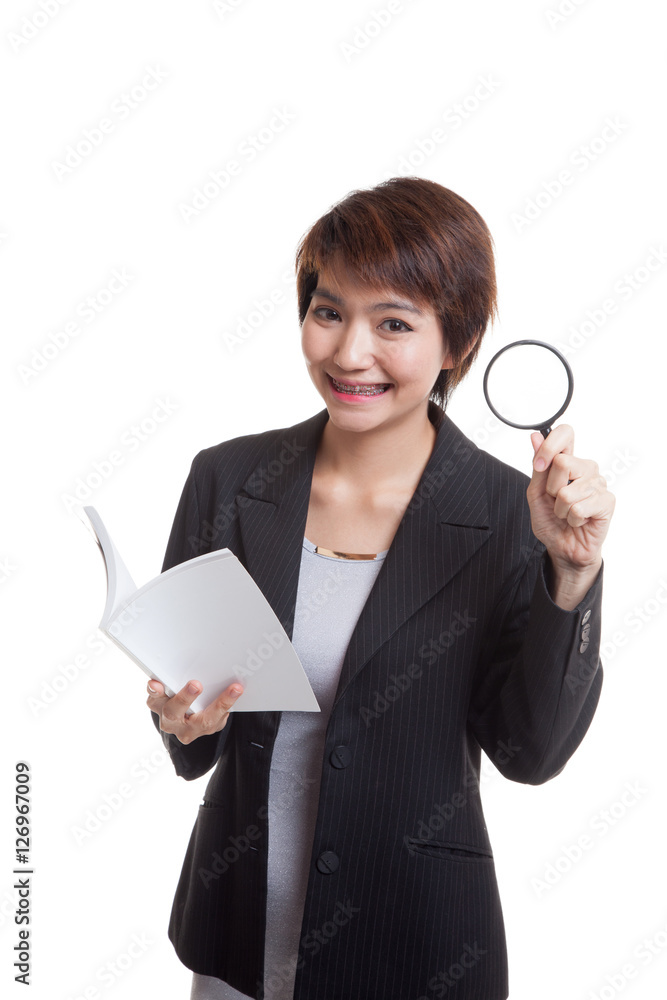 Asian business woman with a book and magnifying glass. Asian business woman with a book and magnifying glass.