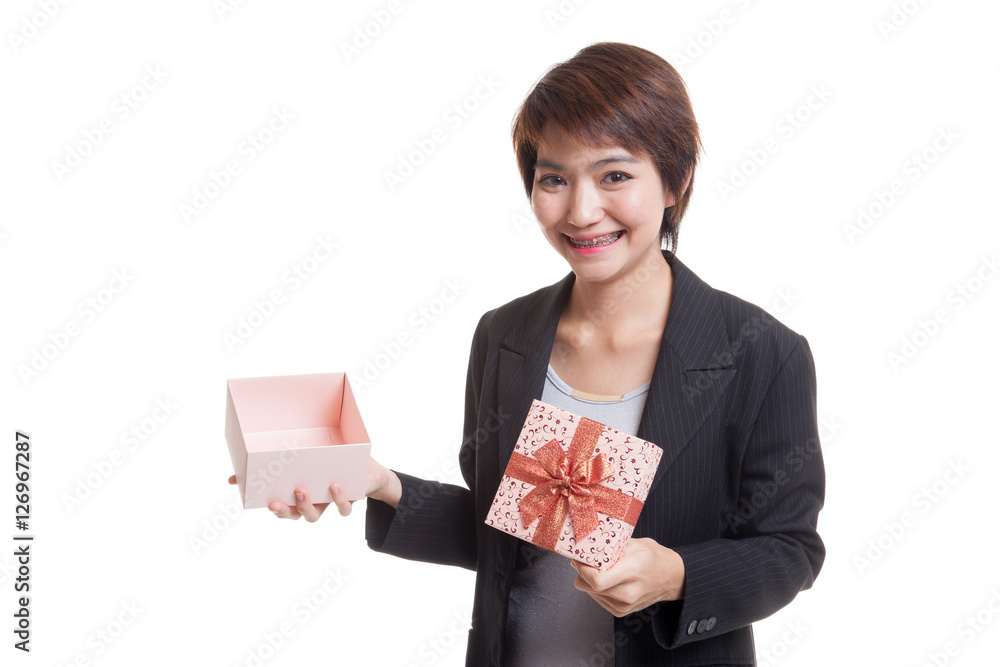 Young Asian business woman open a golden gift box. Young Asian business woman open a golden gift box.