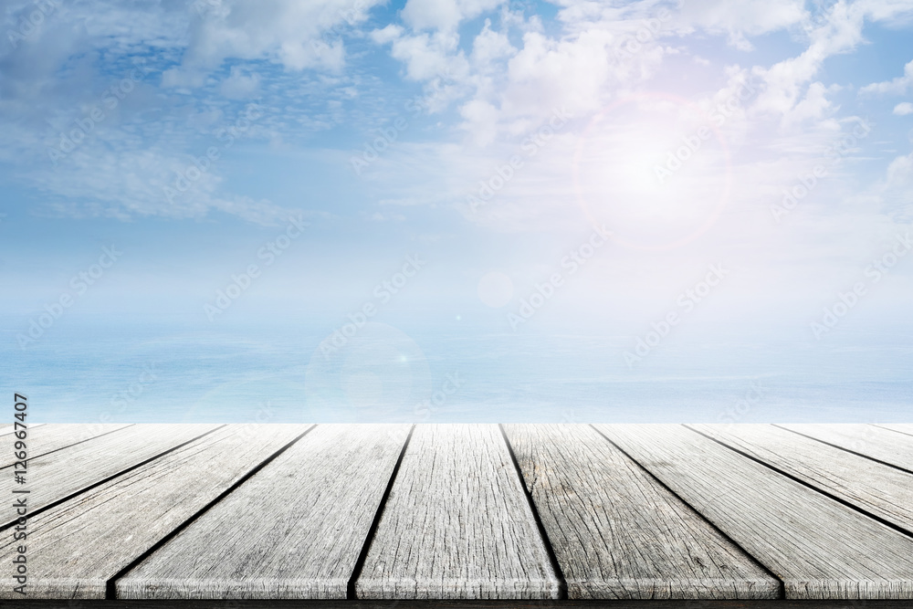 Empty old wooden table with ocean and blue skies background blurred. Concept Summer, Beach, Sea, Ocean, Relax.