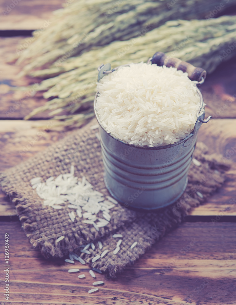 white rice and paddy pile on wood background,Selective focus white rice and paddy pile on wood background,Selective focus