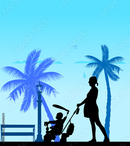 Pregnant woman walking with baby on a tricycle on the beach, one in the series of similar images silhouette