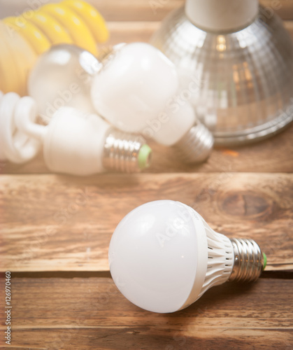 LED bulb and Incandescent bulbs on the wooden