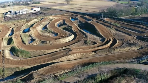 Steady aerial shot of amateur motocross race, slow motion
