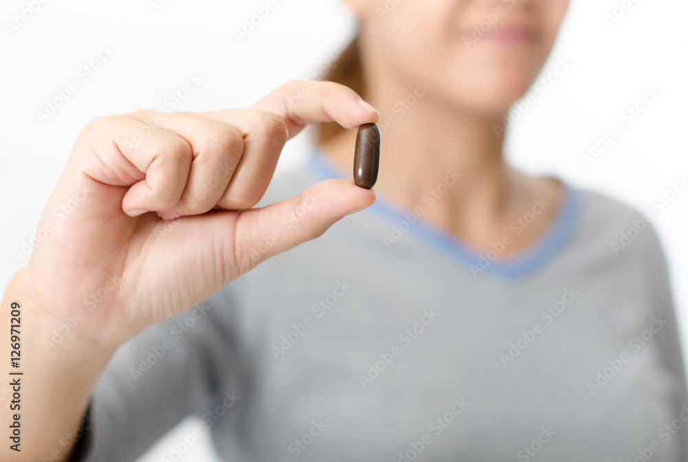 Woman showing capsule pill Fish Oil Capsules,Hea Woman showing capsule pill Fish Oil Capsules,Hea