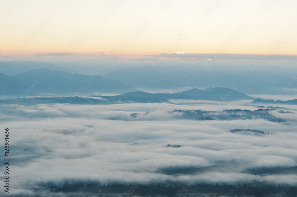 Amazing picturesque landscape of Carpathian mountains on fog and