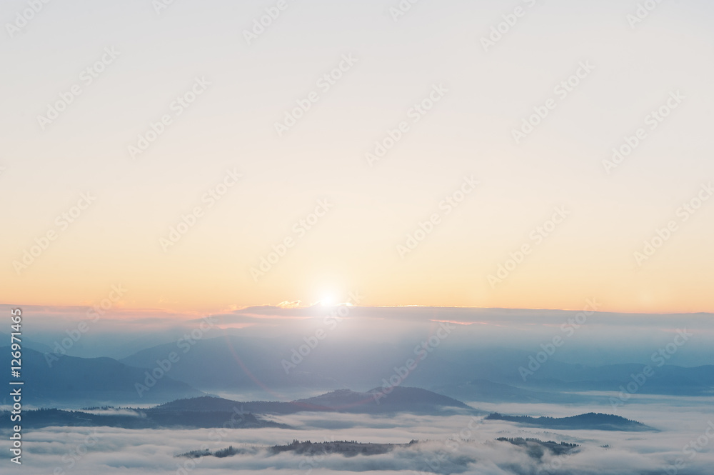 Amazing picturesque landscape of Carpathian mountains on fog and
