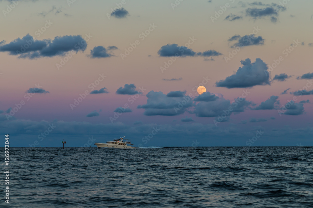 Obraz premium Moon and Fishing boat/Moonrise over the Atlantic ocean.