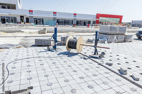 Fotografija Unwinding cable of spool, Coil at construction site