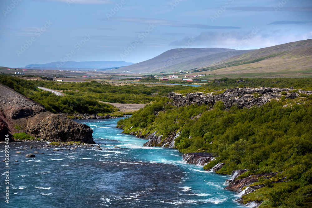 Fototapeta premium Hraunfossar series of waterfalls formed by rivulets streaming ov