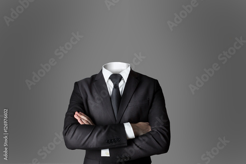 Fototapet businessman without head crossed arms grey background