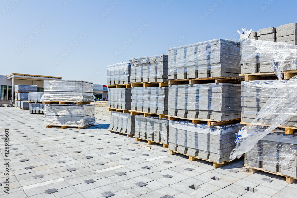 Stack of paving slabs piled on wooden pallets Stack of paving slabs piled on wooden pallets