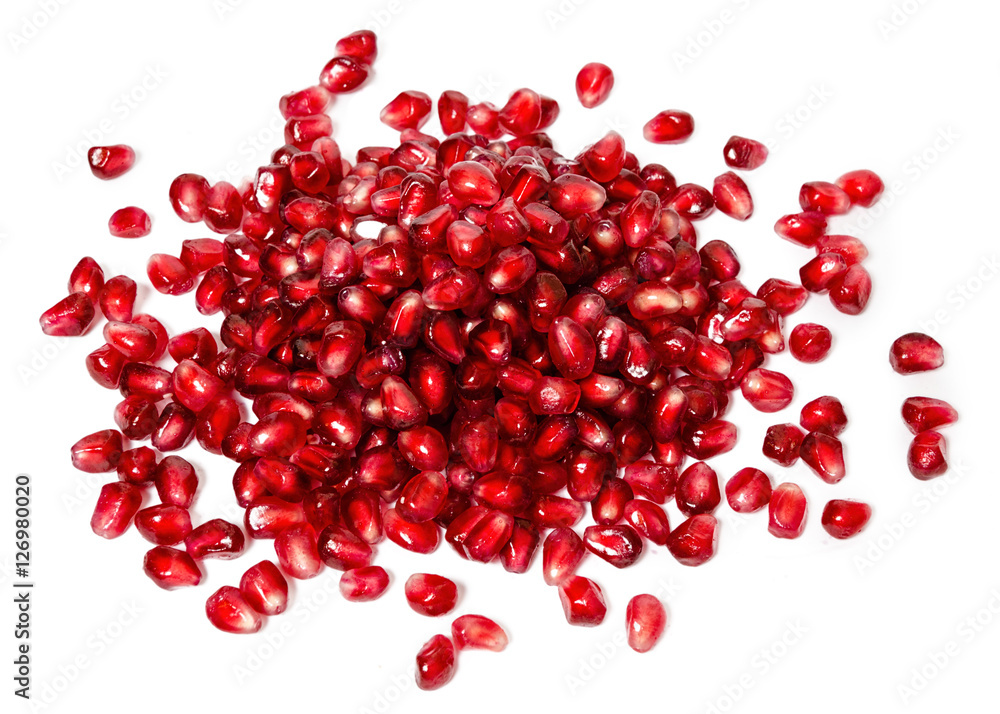 fresh exotic ruby pomegranate seeds, scattered on white background fresh exotic ruby pomegranate seeds, scattered on white background