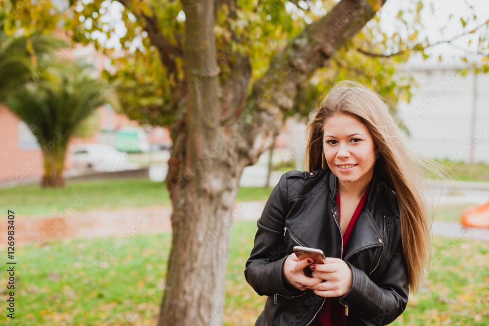 Pretty blonde girl with leather jacket in the street Pretty blonde girl with leather jacket in the street