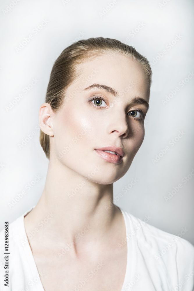 Fototapeta premium Portrait of young blonde beautiful girl in white T-shirt