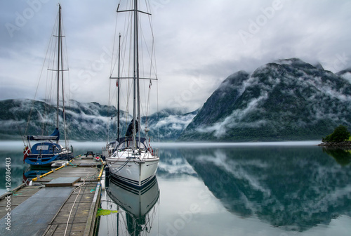 Amazing landscape of lake surrounded by foggy mountains. Norway © olenatur