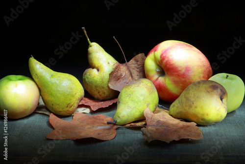 осенние фрукты. Яблоки и груши на черном фоне с осенними листьями  © prohor08