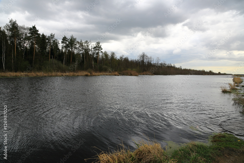 lake with reflection of clouds in summer