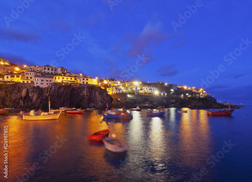 Fototapeta Naklejka Na Ścianę i Meble -  Portugal, Madeira, Twilight view of the fishermen port in the Camara de Lobos.