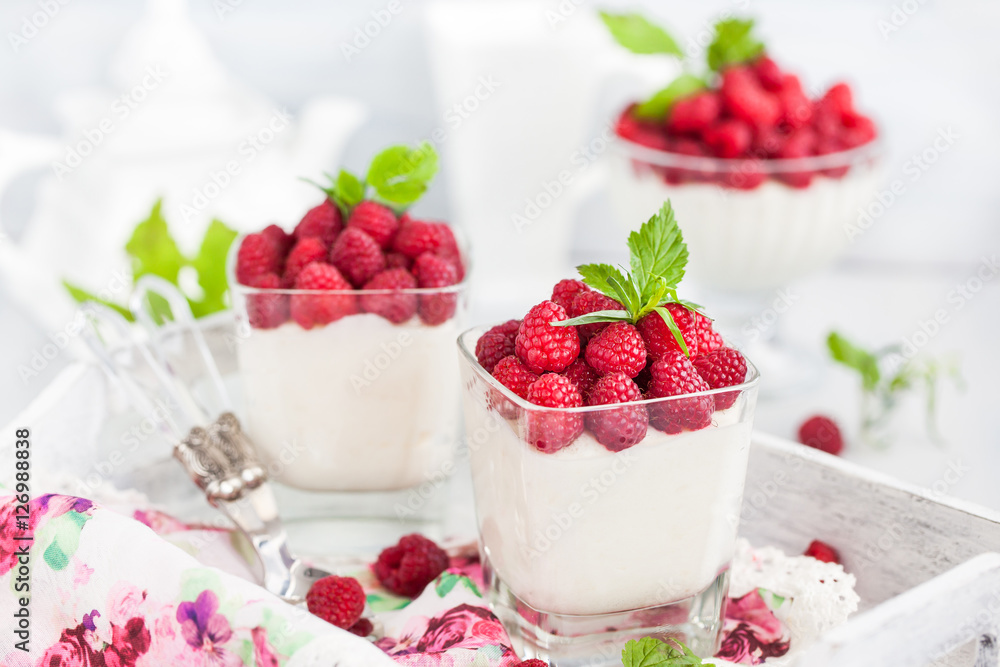 Delicious sweet mousse decorated with fresh raspberries Delicious sweet mousse decorated with fresh raspberries