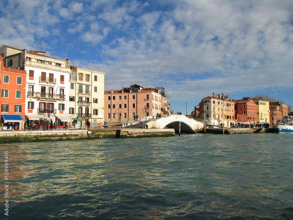 Colorful old buildings and the white stone bridge seen from the Grand Canal of Venice, Italy 