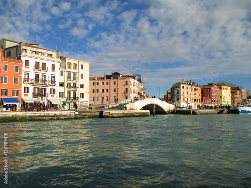 Colorful old buildings and the white stone bridge seen from the Grand Canal of Venice, Italy 