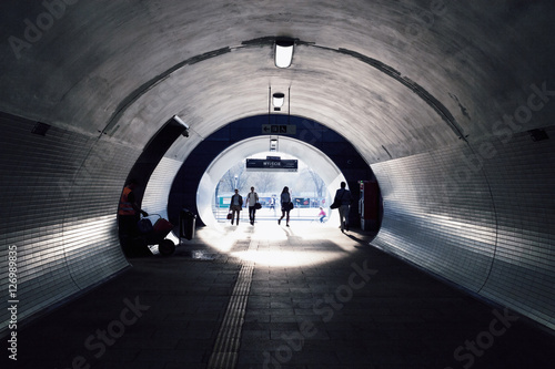 persons goes through an modern underpass