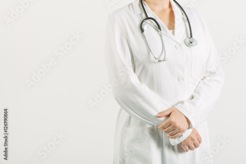 Female general practitioner posing confident in white medical un