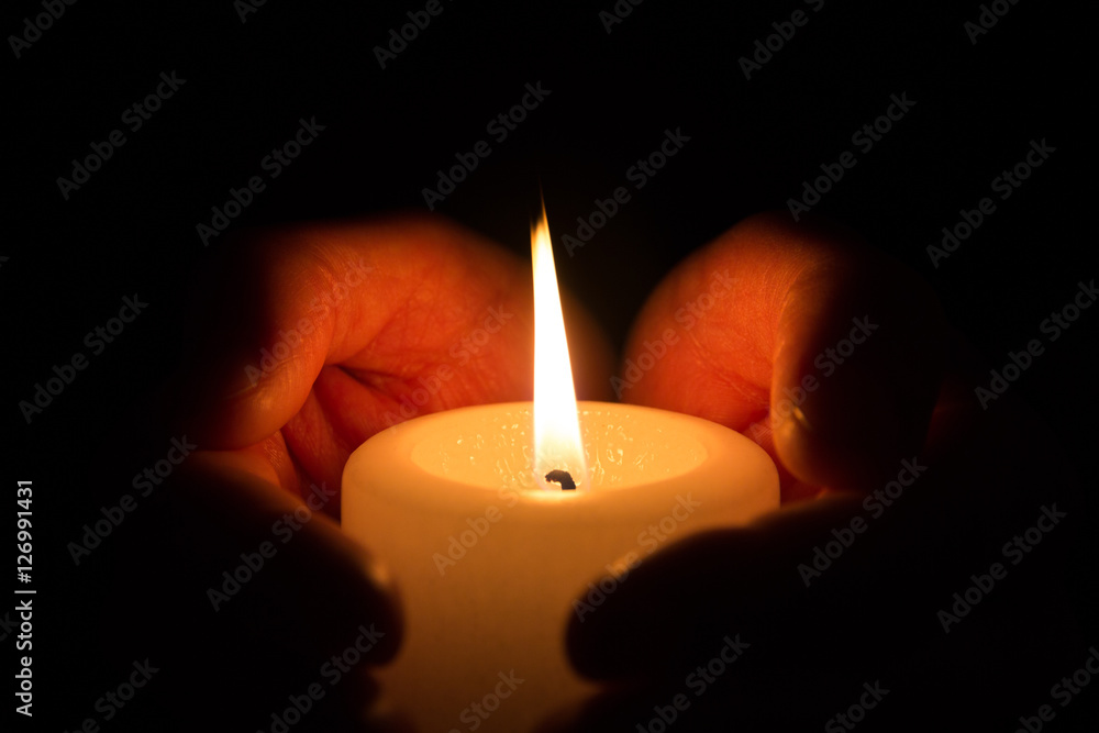 Hände halten und umfassen eine brennende Kerze in der Dunkelheit Stock  Photo | Adobe Stock