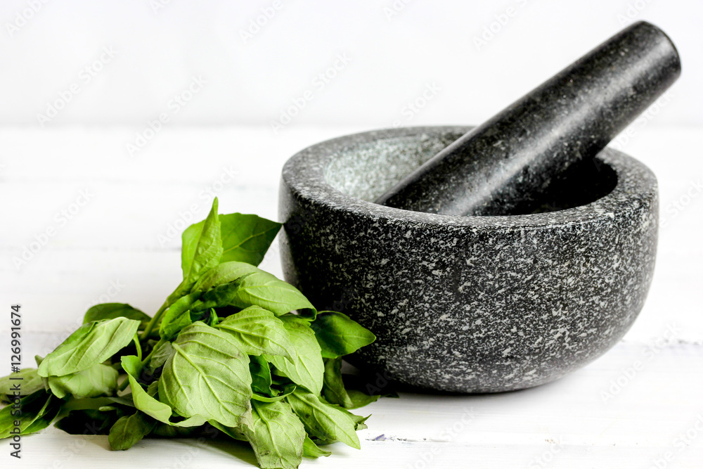 cooking spices in mortar home at wooden background