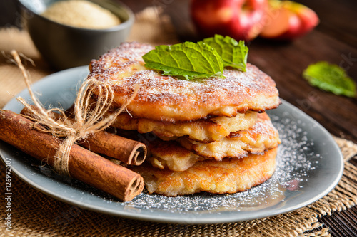 Fotografija Sweet pancakes made of apple, curd and cinnamon