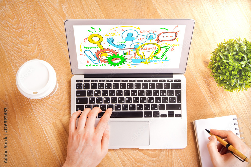 Fototapeta premium Hands using laptop with business sketch