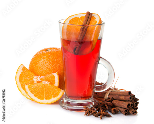 Glass with mulled wine, spices and fruits isolated on white